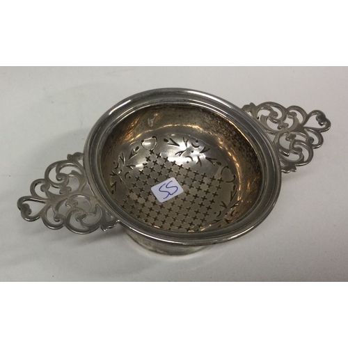 55 - A silver tea strainer on stand. Birmingham. Approx. 81 grams. Est. £100 - £150.