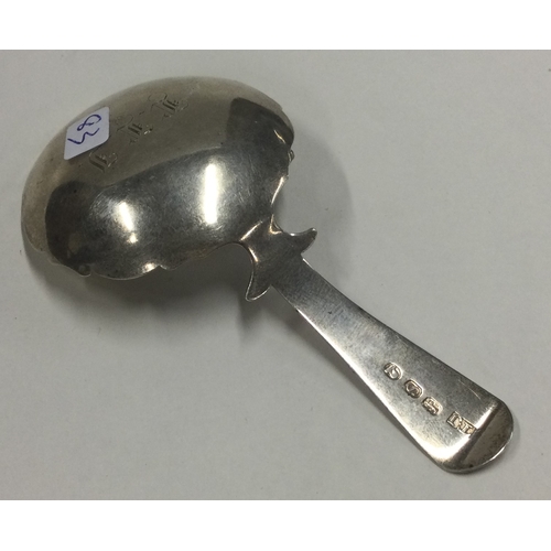 83 - A large George III silver caddy spoon with bright cut decoration to handle and border. London 1813. ... 