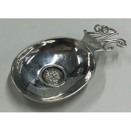 90 - A heavy Modernistic silver caddy spoon with 1937 Coronation coin to centre. Approx. 36 grams. Est. £... 