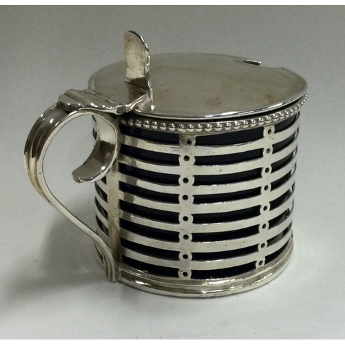 123 - An 18th Century George III pierced silver mounted glass mustard pot. London 1796. Marked to base and... 