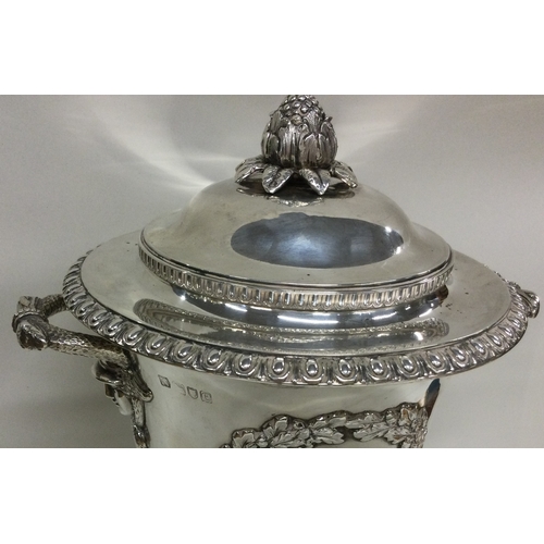 117 - A large Victorian silver wine cooler with figural cover and embossed decoration. London 1899 / 1900.... 