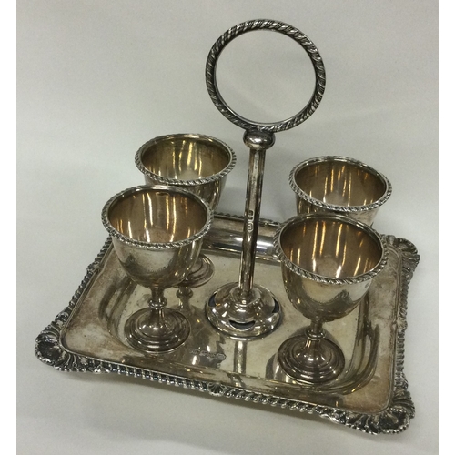 124 - A silver four piece cruet on stand with shell border. Sheffield 1904. By Henry Aitken. Approx. 550 g... 