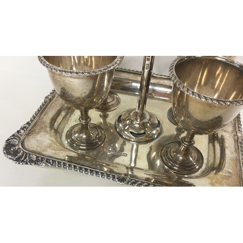 124 - A silver four piece cruet on stand with shell border. Sheffield 1904. By Henry Aitken. Approx. 550 g... 