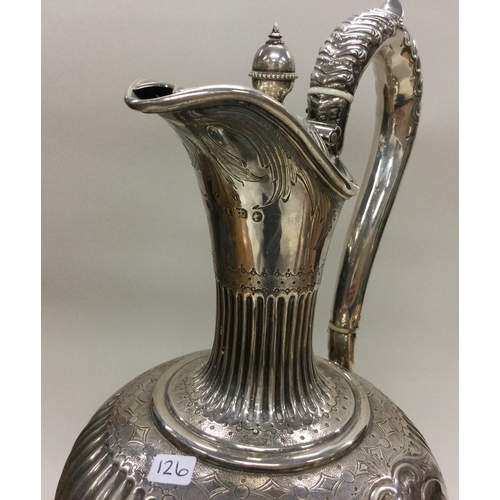 126 - A Victorian silver wine jug with fluted border. Sheffield 1861. By Martin Hall & Co. Approx. 671 gra... 