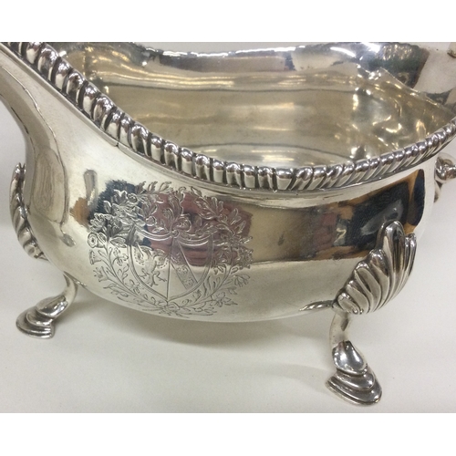 127 - A good heavy pair of Georgian silver sauce boats with central armorials. London 1767. By George Smit... 