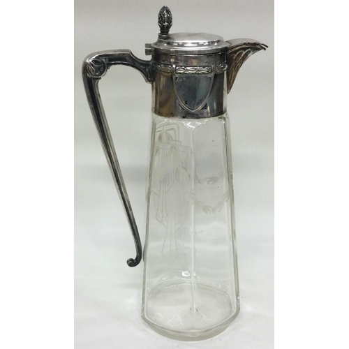 134 - A German silver mounted cut glass claret jug with acorn finial. Est. £150 - £200.