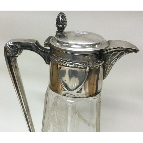 134 - A German silver mounted cut glass claret jug with acorn finial. Est. £150 - £200.