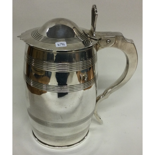 167 - An 18th Century George III silver reeded tankard. London 1797. Approx. 895 grams. Est. £1000 - £1500... 