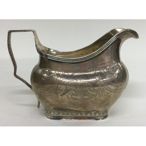 18 - A George III silver jug with chased handle decorated with birds. London 1817. By Thomas Harper. Appr... 