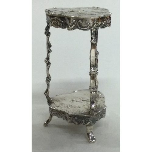 23 - A 19th Century miniature silver table with embossed decoration, bearing import marks. Approx. 41 gra... 