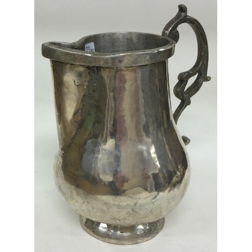 236 - An Indian Colonial silver jug. Marked to base. Approx. 482 grams. Est. £100 - £150.