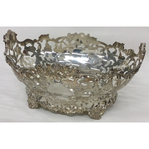 237 - A large silver basket with floral chased decoration. London 1897. By Charles Stuart Harris. Approx. ... 