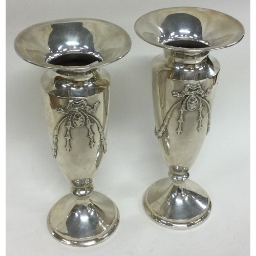 239 - A pair of silver vases with swag decoration. London 1909. By Charles Davenport. Approx. 215 grams. E... 