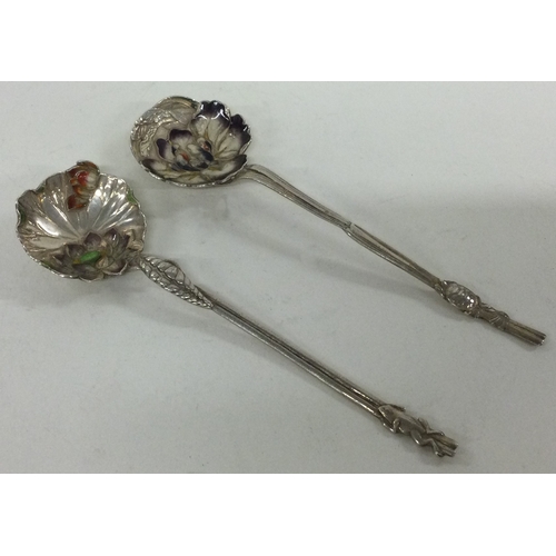 253 - A pair of Meji Japanese silver and enamelled spoons. Approx. 25 grams. Est. £60 - £80.