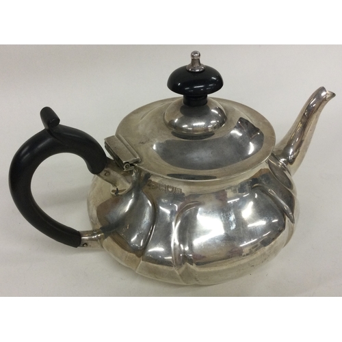 255 - A silver bachelor teapot of fluted design. London 1907. By Pearce & Sons. Approx. 275 grams. Est. £1... 