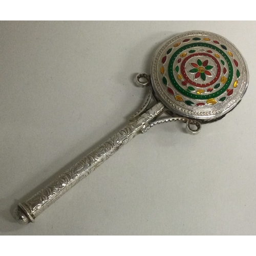 267 - An unusual silver and enamelled rattle. Approx. 33 grams. Est. £20 - £30.