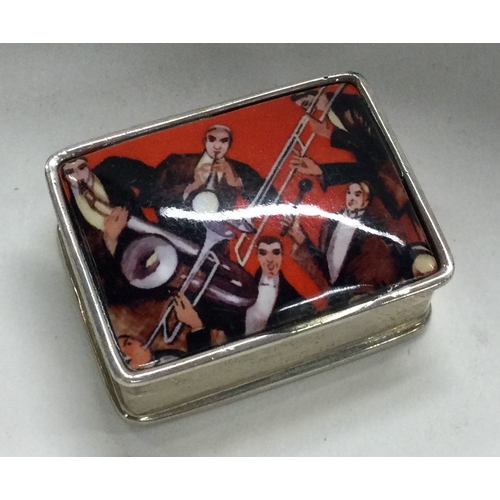 282 - A Sterling silver hinged pill box with musical scene to front. Approx. 20 grams. Est. £20 - £30.