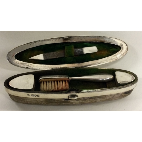 284 - A large silver nail buffer with hinged lid together with two pill boxes and a brush. London 1913. Ap... 