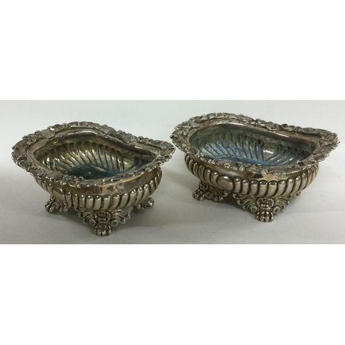 288 - A pair of heavy Georgian silver salt cellars of fluted design on cast feet. London 1822. By George B... 