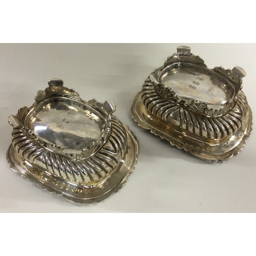 288 - A pair of heavy Georgian silver salt cellars of fluted design on cast feet. London 1822. By George B... 