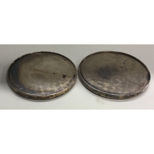 3 - A pair of circular silver coasters. Approx. 220 grams of gross weight. Est. £30 - £50.