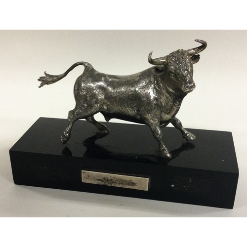 311 - A large silver figure of a bull on plinth. Est. £250 - £300.