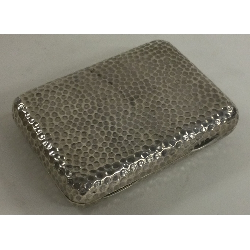 317 - A novelty Victorian silver cigarette case of hammered design. London 1885. By Charles Fox. Approx. 1... 