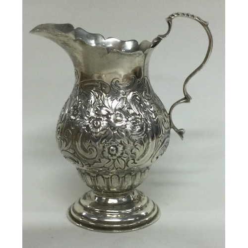 339 - CHESTER: A silver cream jug with chased decoration. Approx. 103 grams. Est. £60 - £80.