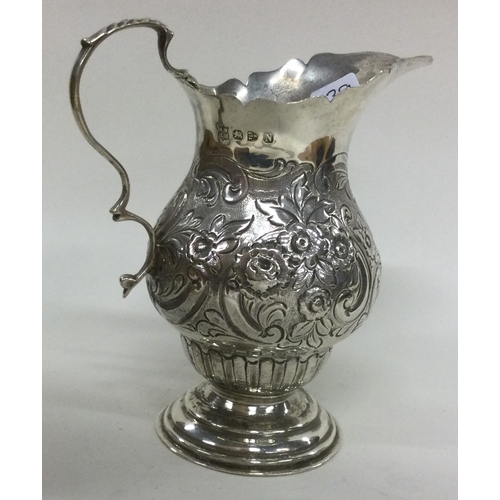 339 - CHESTER: A silver cream jug with chased decoration. Approx. 103 grams. Est. £60 - £80.