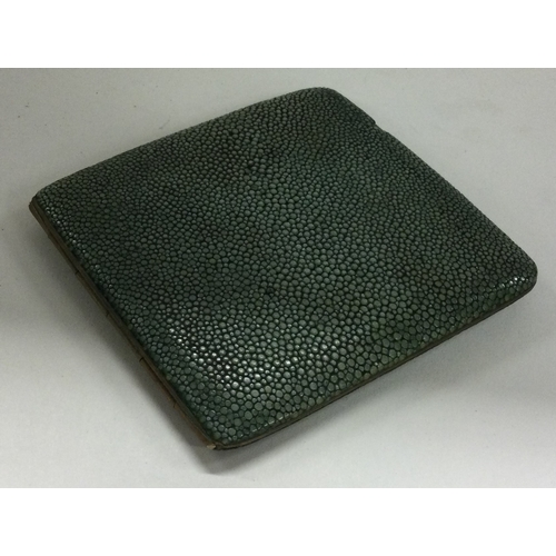 340 - A nickel and shagreen cigarette case. Est. £20 - £30.