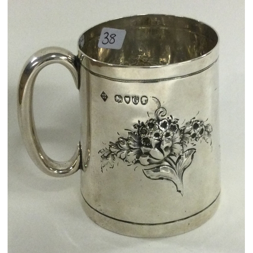 38 - A novelty Victorian silver christening mug chased with flowers. London 1882. By Martin Hall & Co. Ap... 