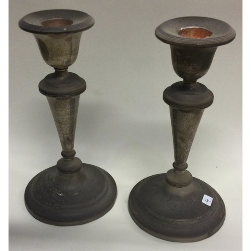 4 - A pair of circular silver candlesticks with reeded decoration. Approx. 750 grams. Est. £50 - £80.