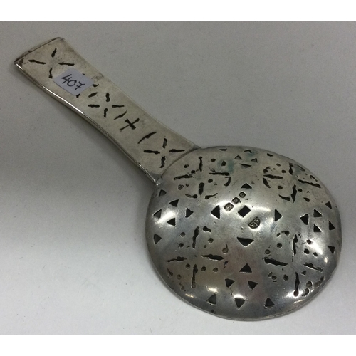 407 - A Dutch silver chased caddy spoon. Marked to front. Approx. 43 grams. Est. £30 - £50.