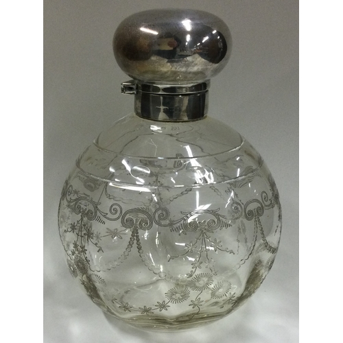 420 - A massive silver mounted and etched glass dressing table bottle. Est. £50 - £80.