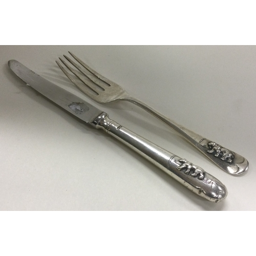 445 - A silver christening knife and fork embossed with bears. Sheffield 1967. By Elkington & Co. Approx. ... 