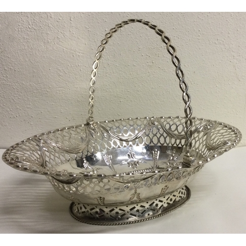 457 - A large 18th Century Georgian silver swing handled basket. London 1772. Possibly by Charles Neale? A... 