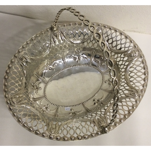 457 - A large 18th Century Georgian silver swing handled basket. London 1772. Possibly by Charles Neale? A... 