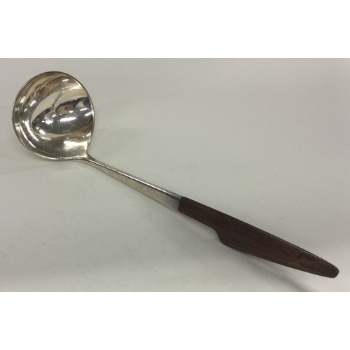 48 - A fine Danish silver ladle with wooden handle. Marked to base. Approx. 56 grams. Est. £80 - £120.