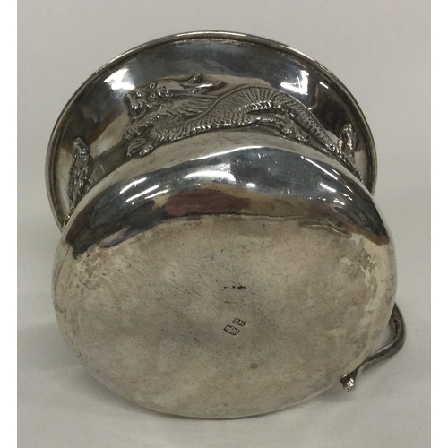 56 - WING NAM: A silver mug chased with dragons. Circa 1900. Approx. 113 grams. Est. £150 - £200.