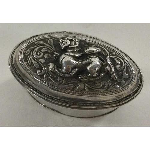 75 - A chased Turkish silver box with lift-off lid decorated with dragons. Approx. 58 grams. Est. £50 - £... 