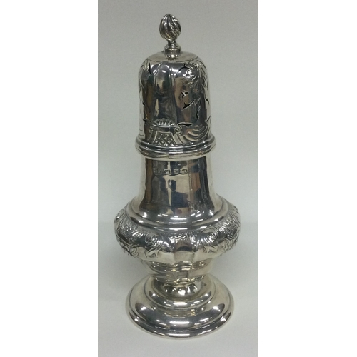 88 - A Victorian silver sugar caster embossed with flowers. Birmingham 1897. By Thomas Hayes. Approx. 191... 