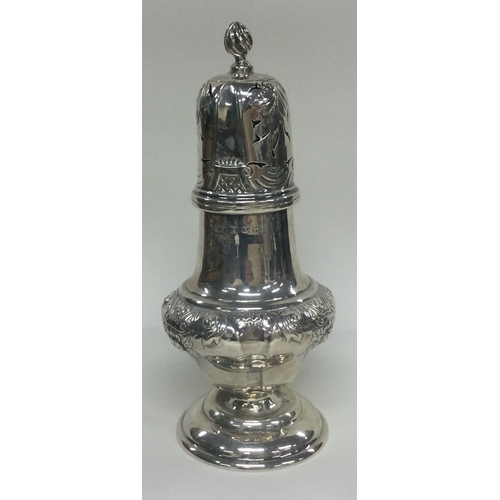 88 - A Victorian silver sugar caster embossed with flowers. Birmingham 1897. By Thomas Hayes. Approx. 191... 