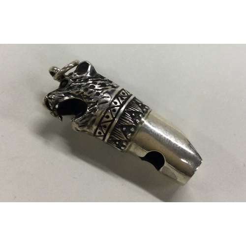 192 - A Sterling silver whistle with figural lion decoration. Approx. 11 grams. Est. £30 - £50.