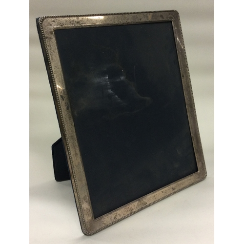 298 - A large silver photo frame. By Carrs. Est. £60 - £80.