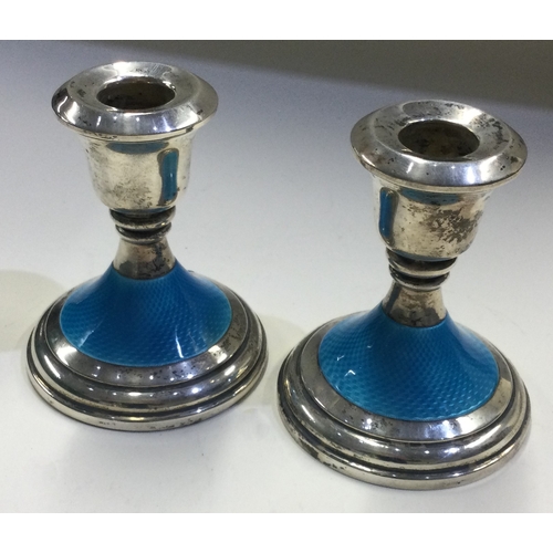 112 - A pair of silver and blue enamelled candlesticks. Birmingham 1964. Approx. 346 grams. Est. £300 - £4... 