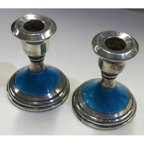 112 - A pair of silver and blue enamelled candlesticks. Birmingham 1964. Approx. 346 grams. Est. £300 - £4... 