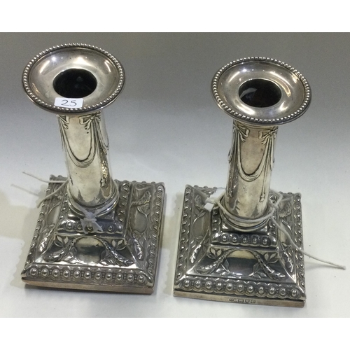 25 - A pair of Victorian silver candlesticks with square bases. London 1900. By Thomas Bradbury. Approx. ... 
