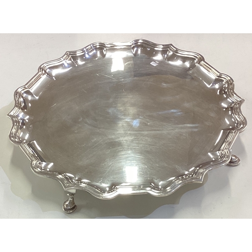 628 - A massive circular silver slaver on four spreading supports. London. By C&C. Approx. 1758 grams. Est... 