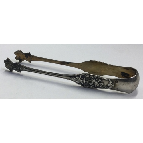 639 - A pair of silver claw ice tongs chased with floral decoration. Approx. 33 grams. Est. £30 - £40.