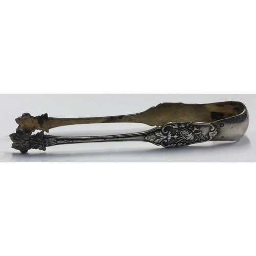 639 - A pair of silver claw ice tongs chased with floral decoration. Approx. 33 grams. Est. £30 - £40.